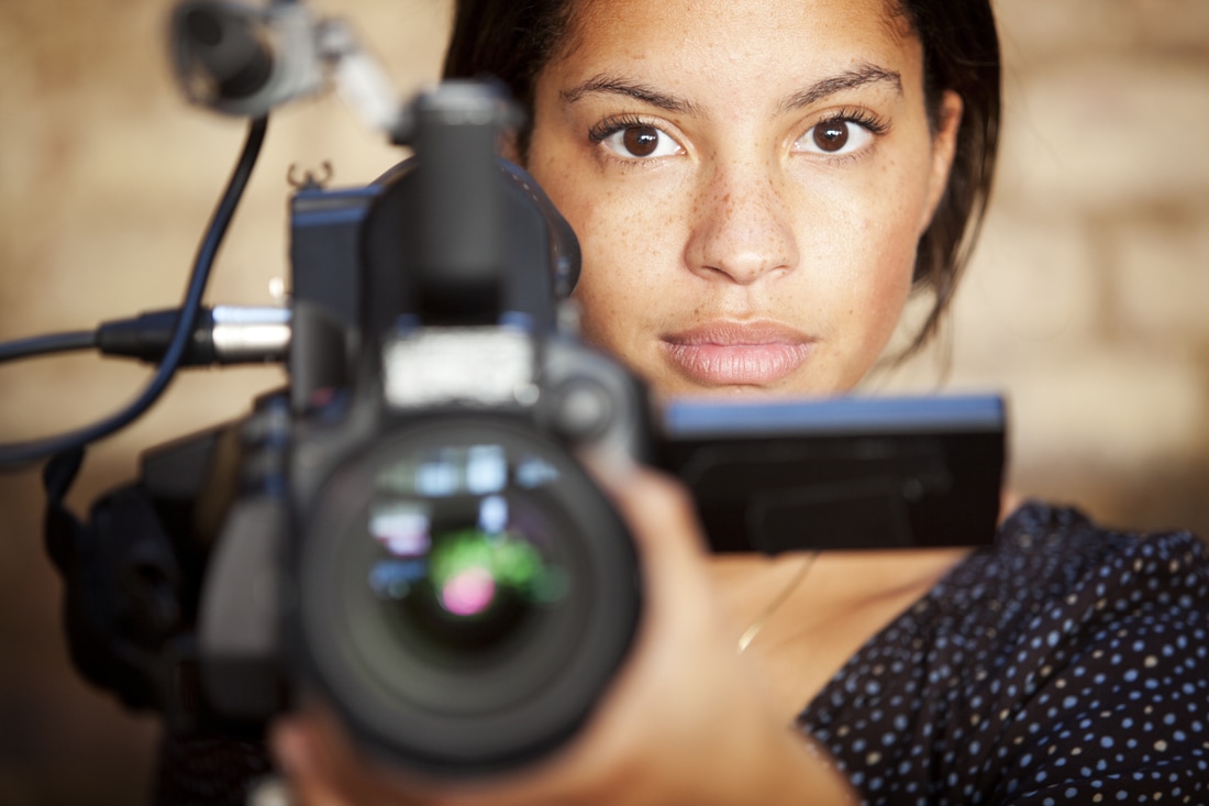 Picture of a woman behind a camera